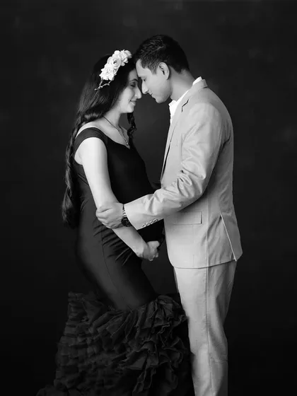 A timeless black and white portrait of a couple sharing a quiet, intimate moment. The floral headpiece adds a touch of softness to this beautiful image.