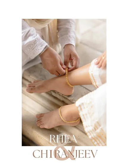 I believe in telling stories through details. This shot of the groom fastening an anklet on his bride's foot is a beautiful, symbolic gesture of love and care, adding a layer of traditional romance to their pre-wedding narrative.