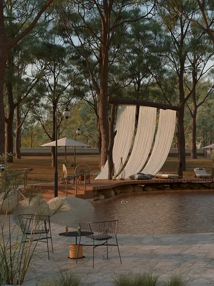 The poolside seating areas are designed for ultimate relaxation. Simple wireframe chairs and umbrellas are placed to offer quiet spots for reading or simply enjoying the view, surrounded by the calming presence of water and trees.