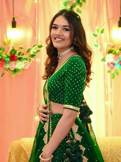 A lovely side profile of Dhruvi. The soft waves in her hair and the simple, glowing makeup create a look of effortless beauty.