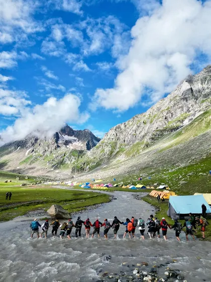 One of the most thrilling parts of the Hampta Pass trek is the river crossing. We hold hands and make our way through the freezing cold water as a team. It's a real bonding experience.
