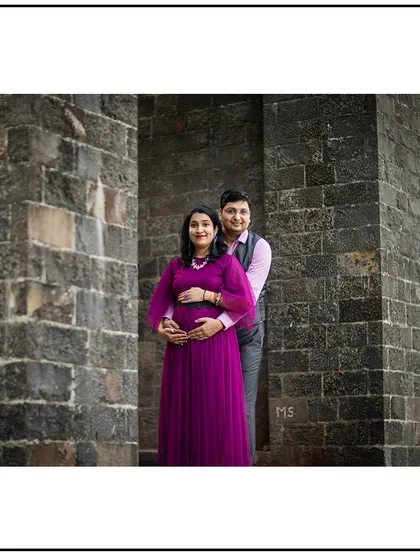 Using architectural elements like these stone pillars to frame the couple adds a sense of timelessness to the portrait.