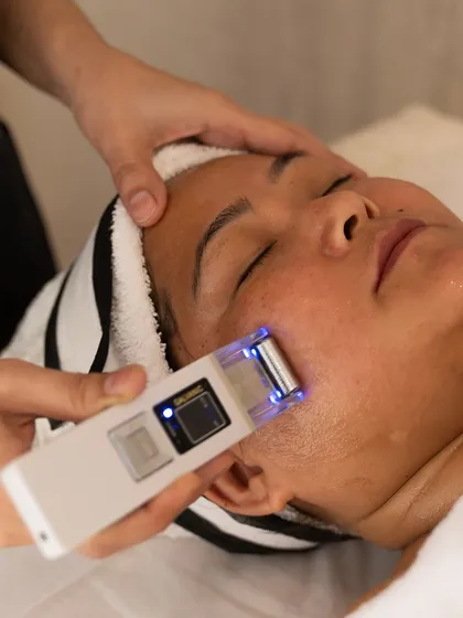 I use tools like this ultrasonic skin scrubber to gently exfoliate and deep clean pores. It's a modern, effective way to achieve smoother, clearer skin during a facial.