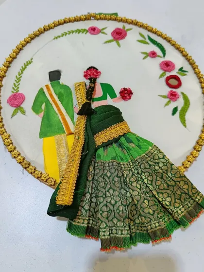This piece showcases creative hoop embroidery, combining fabric painting with 3D fabric elements. It's a beautiful example of how our students learn to mix different techniques to create personalized art.