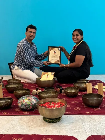 A student receives her Sound Healing certificate, marking the end of a heart-opening and transformative training experience.
