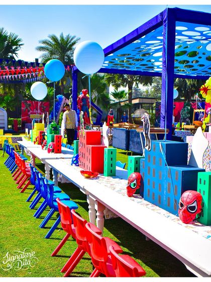 The kids' dining area was transformed into a superhero cityscape. I used custom table runners and centrepieces shaped like skyscrapers, along with character masks at each seat, to make even lunchtime part of the adventure.