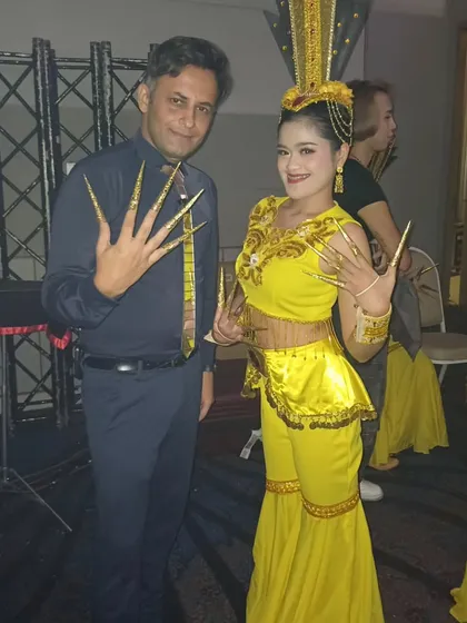 Backstage with a local performer in Thailand. Experiencing the local culture is one of the best parts of performing at international events.