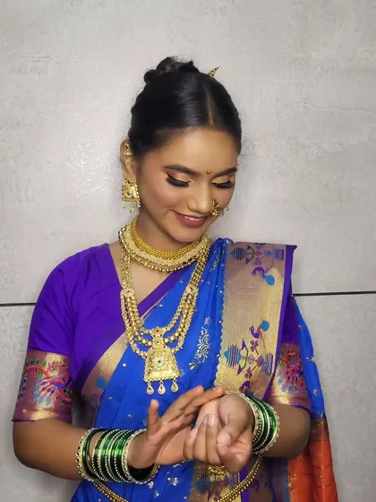 A candid moment of the client admiring her bangles, part of the complete traditional styling.