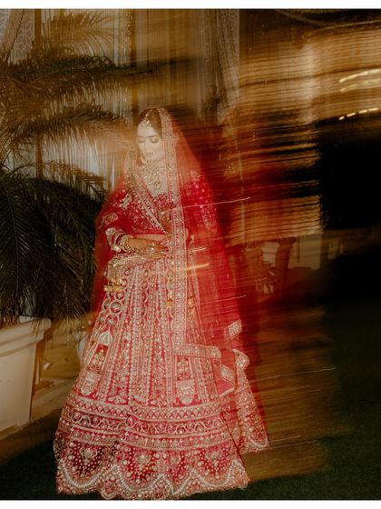 An artistic shot of the bride using a slow shutter speed to create a motion blur effect, adding a dynamic and dreamy quality.