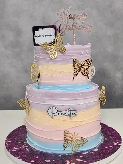 Inspired by Taylor Swift's "Lover" album, this two-tier pastel rainbow cake with butterflies is a sweet symphony of flavors for a true Swiftie.