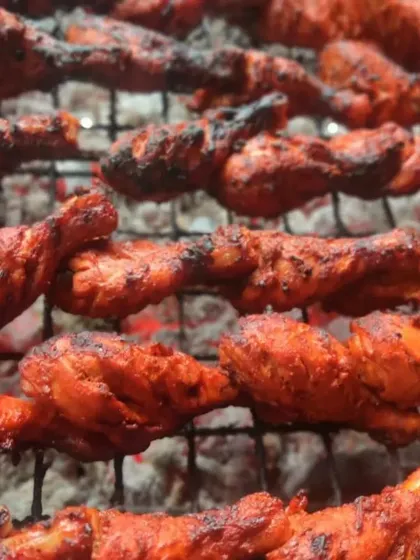 The heart of our cooking is in traditional techniques. Here, our chicken tangdi kababs are grilled over charcoal, giving them an authentic smoky flavor that you can't get from an oven.