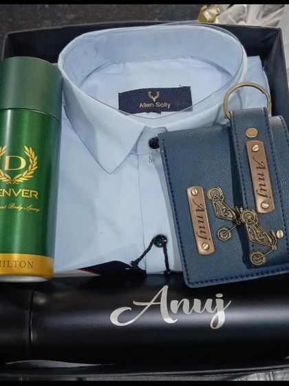 A cool blue hamper with an Allen Solly shirt, a personalized wallet and keychain, and a name-engraved flask.