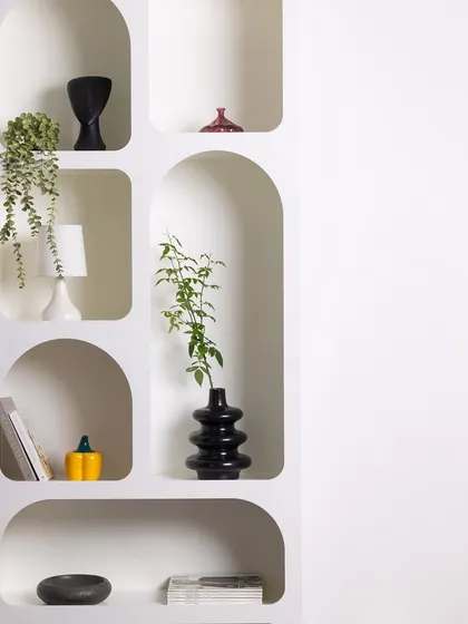 This wider shot of the arched shelving unit emphasizes its clean, geometric forms and its potential as a minimalist backdrop for product or portrait photography.