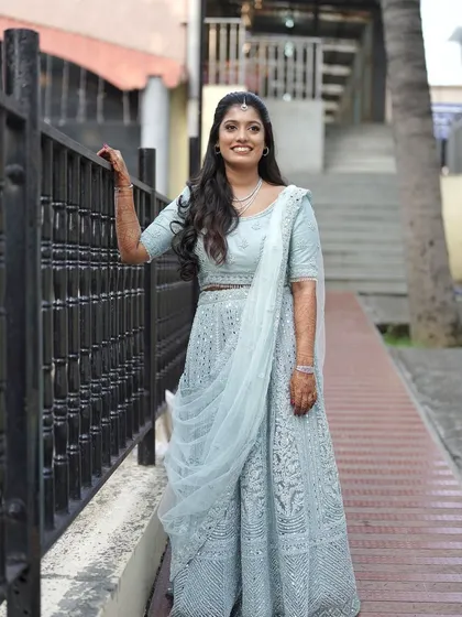 A full-length view of the pastel blue reception lehenga. The overall look is soft, dreamy, and romantic, perfect for a modern bride.