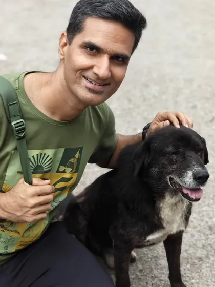A photo of Hardik with a friendly dog, illustrating the yogic principle of Ahimsa (non-violence) and compassion for all living beings.