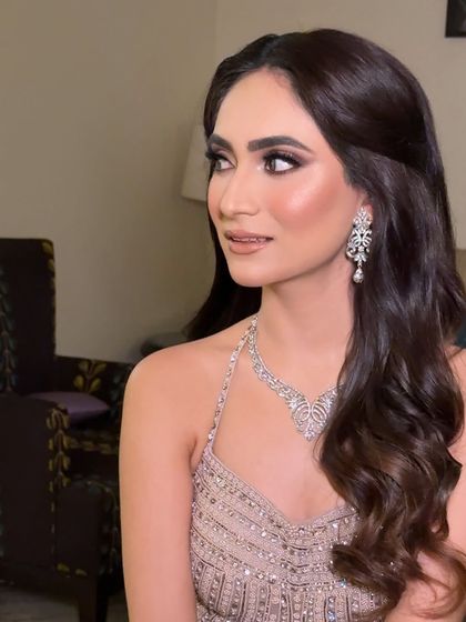 A side profile showcasing the beautiful, shimmering eye makeup and the soft contour that defines her features.