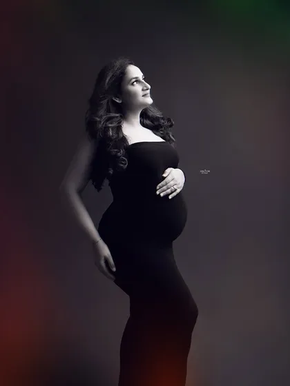 A simple, classic profile pose against a dark background. This technique emphasizes the bump and creates a timeless, contemplative mood.