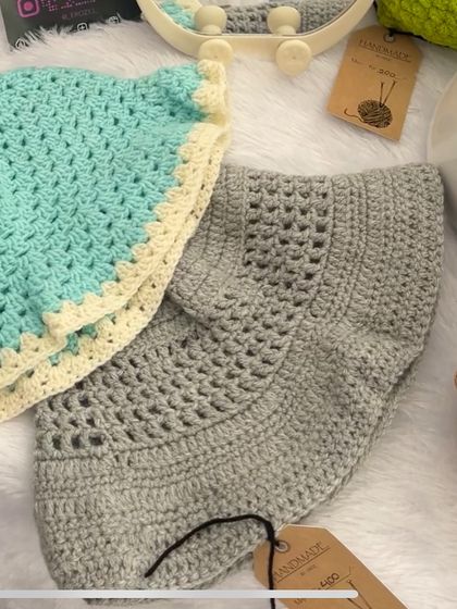 Here are two of my crochet bucket hats side-by-side. One is a solid grey and the other is a lovely sea green with a cream-colored trim, showing some of the color options available.