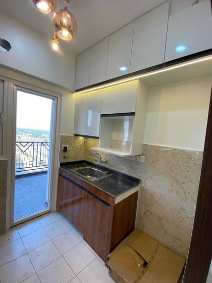 A view of the sink and preparation area, showing the simple yet effective use of space in a budget-friendly design.