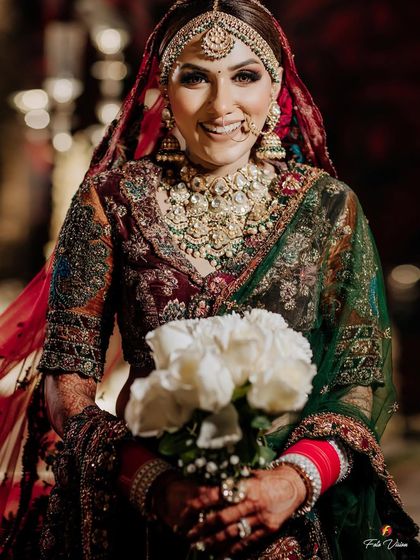 The bride's radiant smile as she holds her white rose bouquet, a perfect picture of bridal happiness and elegance.