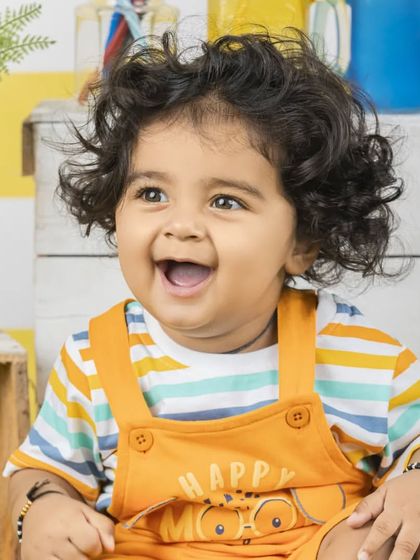 The most infectious, happy laugh! This close-up portrait captures the pure joy of childhood.