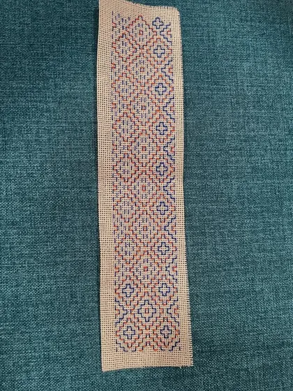 A finished Kasuti bookmark with a repeating geometric pattern. This type of counted-thread embroidery is a proven stress buster and a wonderful way to practice mindfulness.