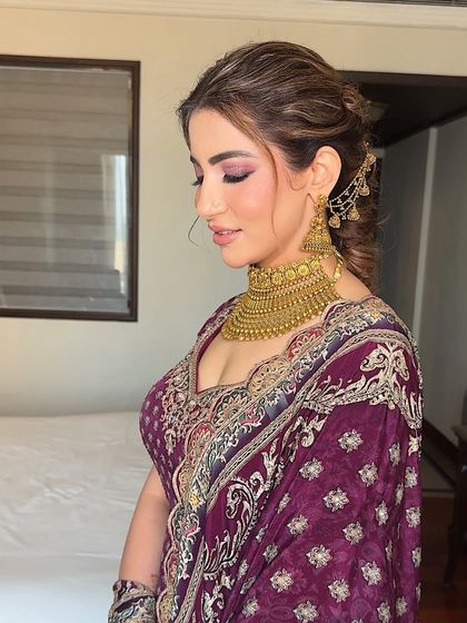 A side profile showing the beautiful, blended eye makeup and the elegant updo. The look is sophisticated and timeless.