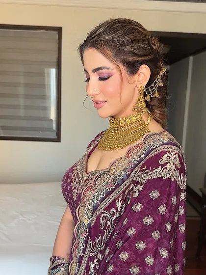 A side profile showing the beautiful, blended eye makeup and the elegant updo. The look is sophisticated and timeless.