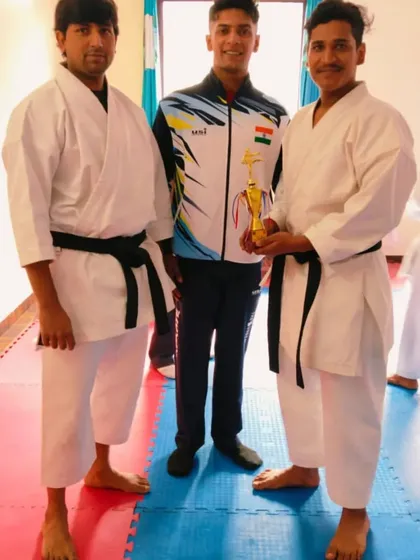 Awarding a trophy to a student for his excellent performance during the black belt grading test.