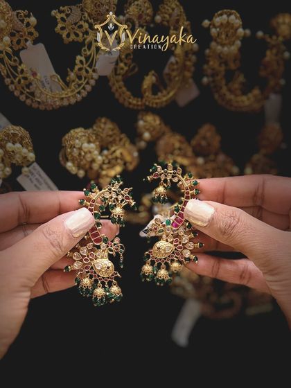 A slightly different angle of the peacock earcuffs, showing the detailed stonework and the way they curve along the ear.
