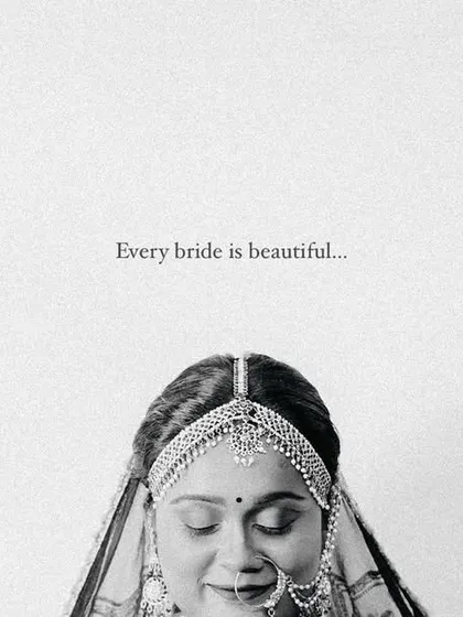 A minimalist and elegant black and white bridal portrait. The simple composition and the bride's serene expression make this a powerful image.