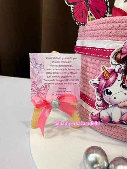 A close-up of the personalized thank you card for Simone's first birthday celebration.