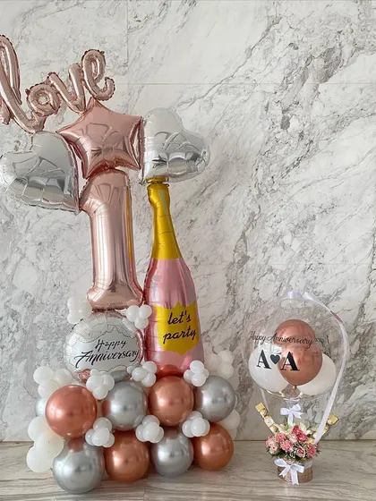 A perfect duo for a first anniversary celebration. I paired a large, custom balloon arrangement with one of my signature hot air balloon gifts, which held fresh flowers and chocolates.
