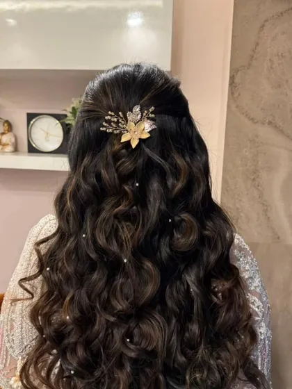 The hairstyle is just as important as the makeup. This half-up style with soft curls and a delicate hair accessory completes the elegant engagement look.
