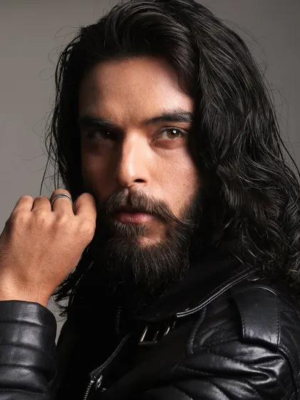 A strong and masculine look. For this portrait, the grooming was about enhancing his natural features, with a focus on the beard and long, healthy-looking hair.