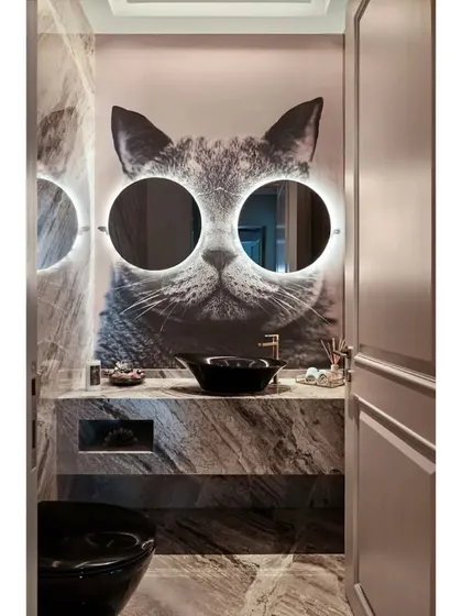 Who said powder rooms have to be boring? I love creating dramatic, memorable spaces that surprise and delight. This "Meow" bathroom, with its custom cat wallpaper and illuminated mirror glasses, is a perfect selfie spot and a testament to my belief that every corner of a home should have personality.