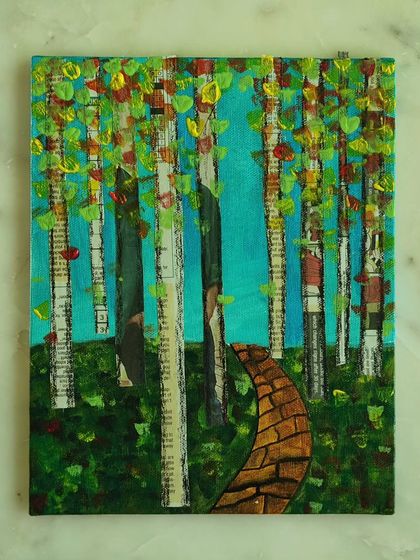 A beautiful mixed-media canvas featuring abstract trees made from newspaper collage. This piece combines acrylic painting with upcycled materials to create a textured and nature-inspired work of art.