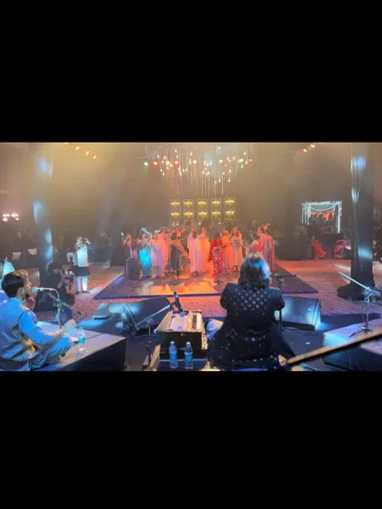 Another shot from the back of the stage, showing the audience captivated by the performance on the dance floor.
