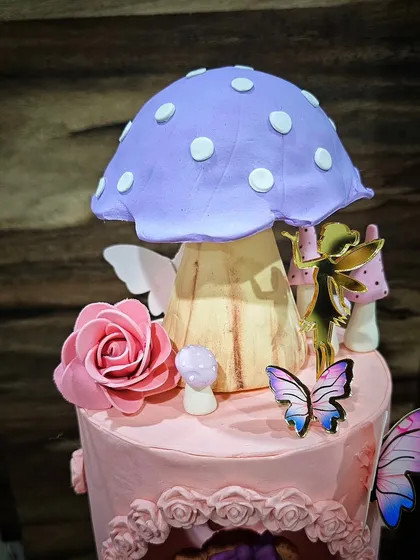 Detail of the large, sculpted mushroom and other fairy-like elements.