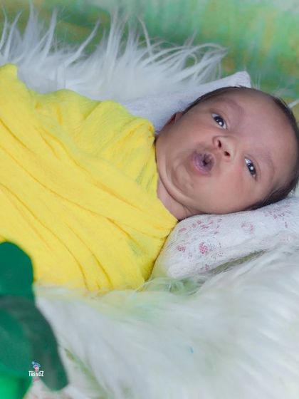 An awake and expressive newborn making a cute face. Not all newborn shots have to be sleepy, these alert moments are just as precious.