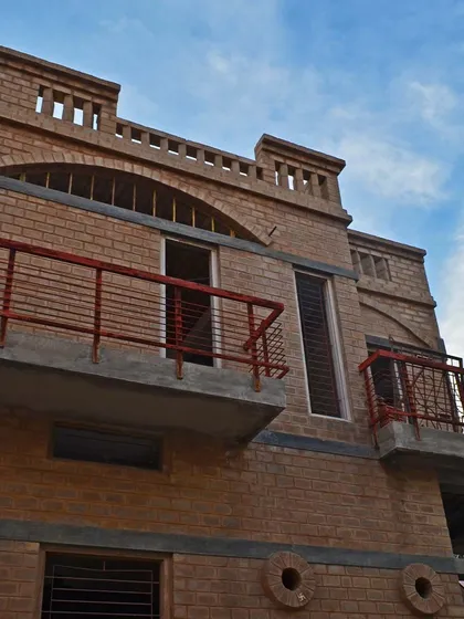The elements of this facade, from the brickwork to the arches and parapet, work in harmony to create a unified design.
