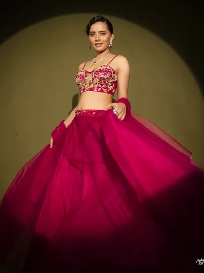 Another motion shot, showing the beautiful volume of the lehenga. The sleek hair and polished makeup provide a perfect contrast.