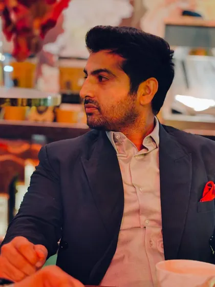 A candid, thoughtful pose during a dinner meeting.