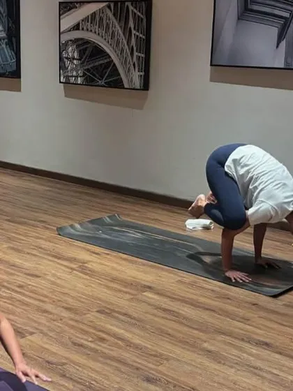 Students practicing Bakasana (Crow Pose) during a workshop. Arm balances are not just about strength, but also about overcoming fear and learning to balance with focus.