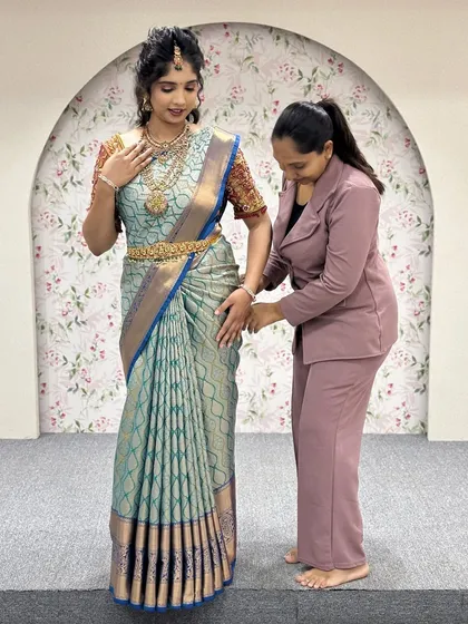 Making final adjustments to ensure every detail is perfect. This behind the scenes shot shows the care I take in creating a flawless drape for my clients and models.