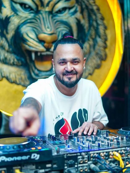 In my element at Badmaash, with the signature tiger logo in the background. This venue has a special vibe, and I love playing here.