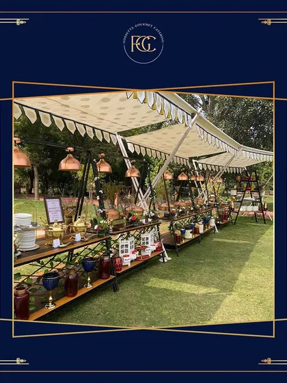 A grand buffet arrangement under elegant tents for a large outdoor gathering. This demonstrates our capacity for managing extensive catering setups for weddings and other significant events.
