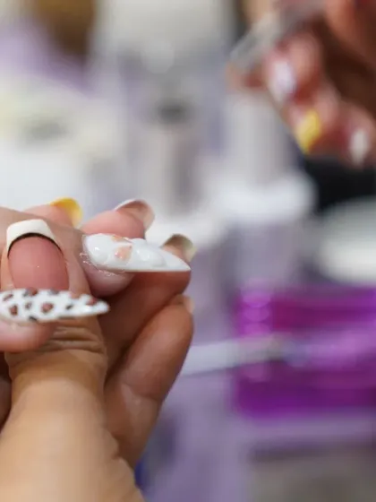 The art of detail. Here, our technician applies delicate elements to a 3D nail design, showcasing the precision that goes into every custom set.
