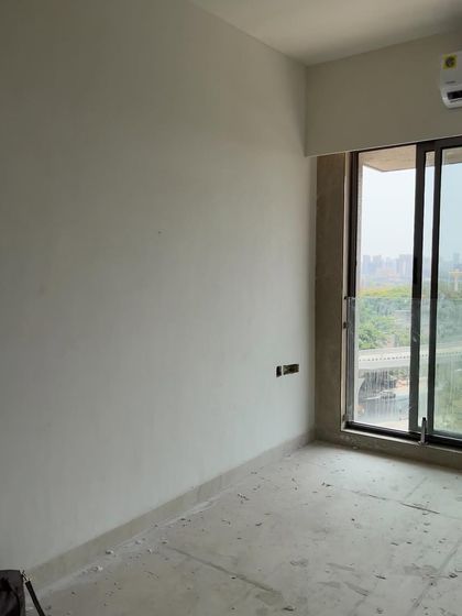 The beginning of a transformation. This "before" shot shows an empty room with unfinished walls, a blank slate that we reimagined into a warm and inviting part of a 1200-square-foot traditional home.