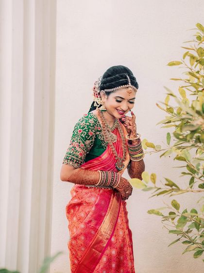 A shy, happy smile from the bride. The makeup is soft enough to let her natural expressions shine through.